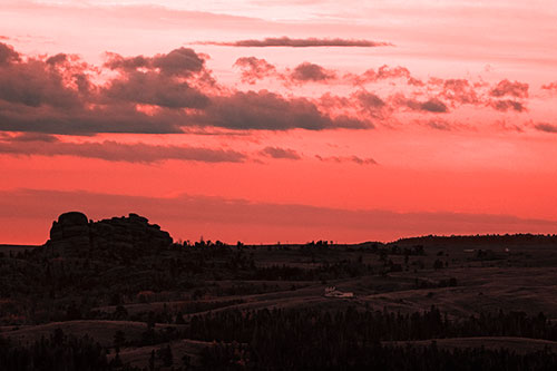 Sunrise Over Rock Formations On The Horizon (Red Tone Photo)