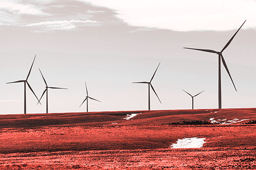 Wind Turbines Scattered Around Melting Snow Patches (Red Tone Photo)