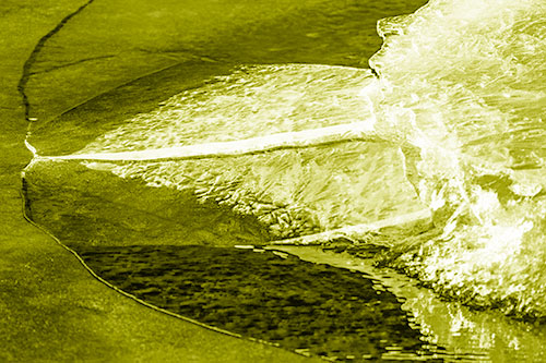 Abstract Ice Sculpture Forms Atop Frozen River (Yellow Shade Photo)
