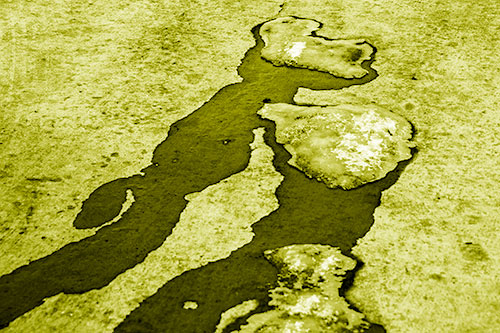 Melting Ice Puddles Forming Water Streams (Yellow Shade Photo)
