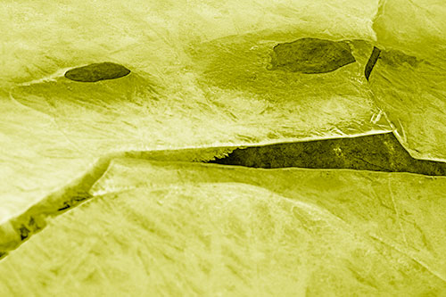 Rock Face Emerges Among Cracked Frozen Ice (Yellow Shade)