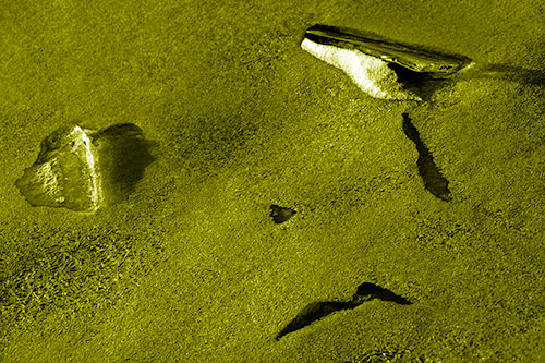 Sad Teardrop Ice Face Appears Atop Frozen River (Yellow Shade Photo)