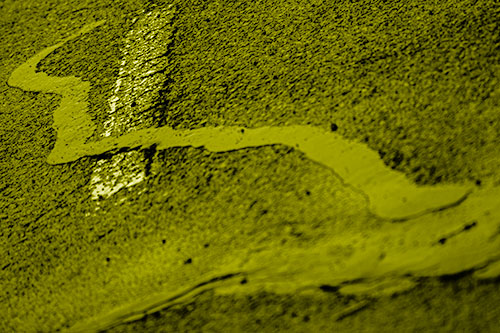 Slithering Tar Creeps Over Pavement Marking (Yellow Shade Photo)