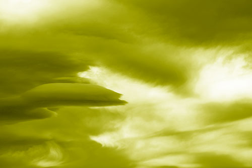 Smooth Cloud Sails Along Swirling Formations (Yellow Shade Photo)