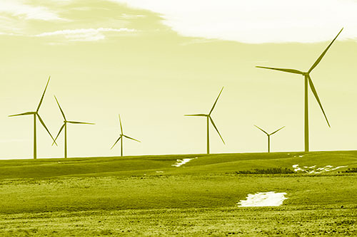Wind Turbines Scattered Around Melting Snow Patches (Yellow Shade Photo)