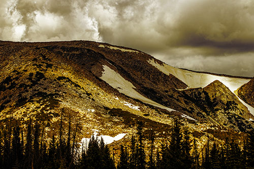 Clouds Cover Melted Snowy Mountain Range (Yellow Tint)