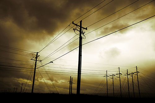 Crossing Powerlines Beneath Rainstorm (Yellow Tint Photo)