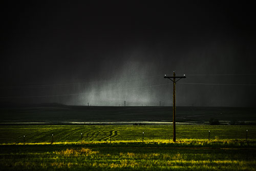 Distant Thunderstorm Rains Down Upon Powerlines (Yellow Tint Photo)