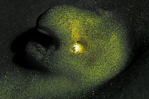 Glowing Eyed Snow Face Emerges Above Soil (Yellow Tint)