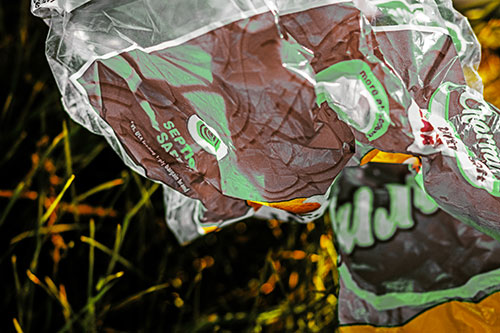 Growling Plastic Charmin Bag Among Grass (Yellow Tint)