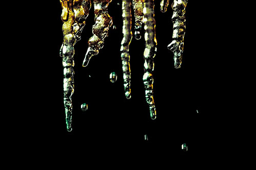 Jagged Melting Icicles Dripping Water (Yellow Tint Photo)