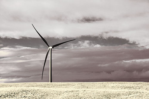 Lone Wind Turbine Standing Along Dry Prairie Horizon (Yellow Tint Photo)