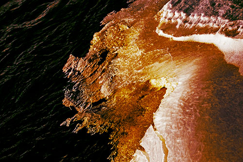 Melting Ice Face Creature Atop River Water (Yellow Tint Photo)