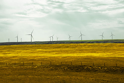 Wind Turbines Scattered Along Prairie Horizon (Yellow Tint)