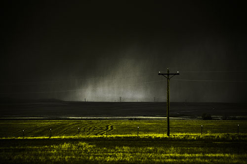 Distant Thunderstorm Rains Down Upon Powerlines (Yellow Tone Photo)
