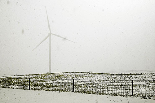 Fenced Wind Turbine Among Blowing Snow (Yellow Tone)