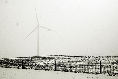 Fenced Wind Turbine Among Blowing Snow (Yellow Tone Photo)