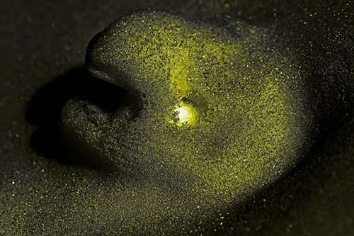 Glowing Eyed Snow Face Emerges Above Soil (Yellow Tone)