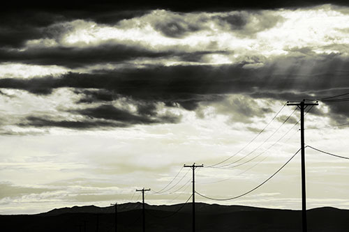 Powerline Silhouette Entering Mountain Range (Yellow Tone Photo)