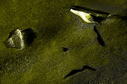 Sad Teardrop Ice Face Appears Atop Frozen River (Yellow Tone Photo)