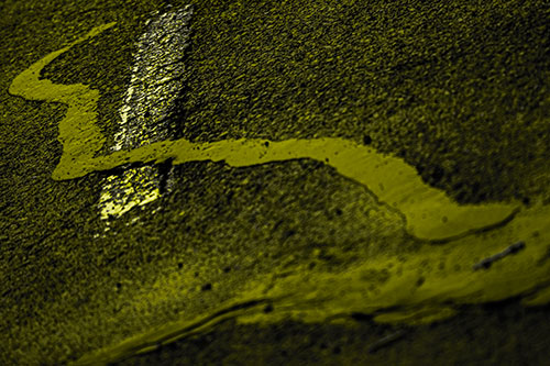 Slithering Tar Creeps Over Pavement Marking (Yellow Tone Photo)