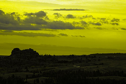 Sunrise Over Rock Formations On The Horizon (Yellow Tone Photo)
