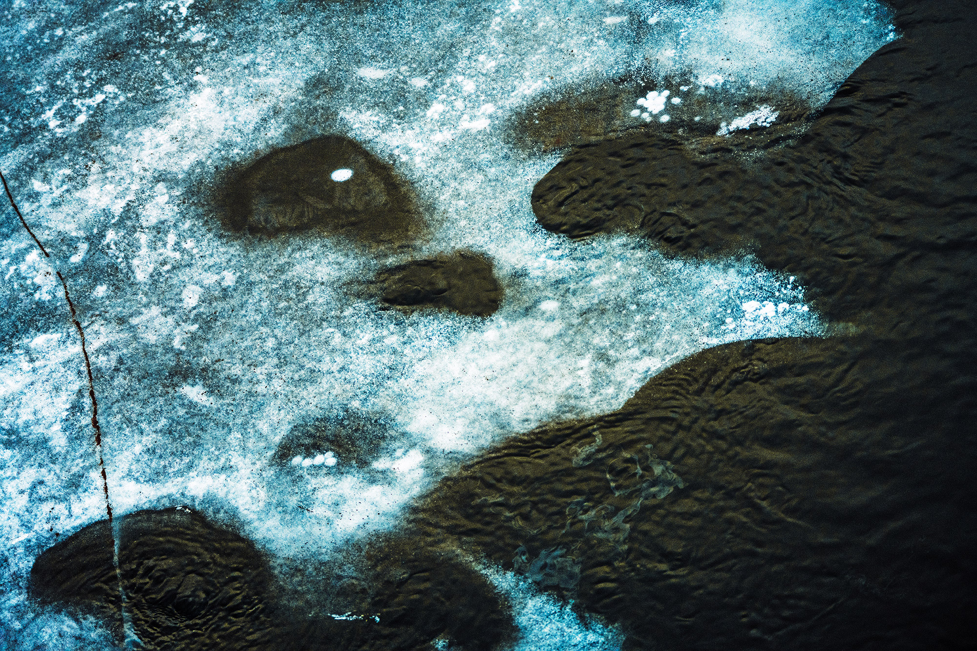Disintegrating Ice Face Melting Among Flowing River Water (Color Photo)